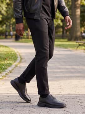 Mens Riginalgrand Cityspectre Wholecut Oxfords – Monochromatic black slim-fit trousers and a high-quality black pima cotton t-shirt layered under a black leather bomber jacket for a sharp evening outing.