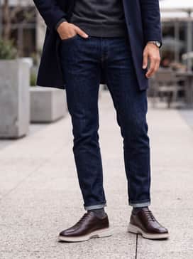 Mens Riginalgrand Cityspectre Wholecut Oxfords – Dark indigo slim-fit jeans combined with a charcoal merino wool turtleneck and a tailored navy topcoat for a sophisticated evening ensemble.