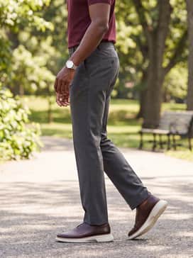 Mens Riginalgrand Cityspectre Wholecut Oxfords – Charcoal grey dress slacks styled with a burgundy polo shirt and a minimalist silver watch to emphasize the rich brown tones of the leather.