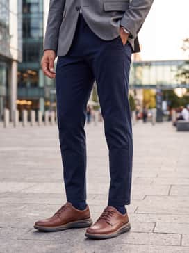 Dark wash straight-leg indigo denim worn with a charcoal grey merino wool turtleneck and a tailored navy blazer for a sharp dinner ensemble.