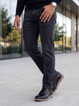 Mens Zergrand Remastered Plain Toe Oxfords – Dark charcoal straight-leg denim jeans worn with a black fine-knit turtleneck and a tailored camel wool overcoat for a sleek, monochromatic-meets-neutral look.