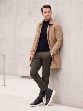 Mens Zergrand Wfa 20 Wingtip Oxfords – Tapered olive green trousers combined with a black mock-neck jersey and a tan technical trench coat for a sophisticated, weather-ready street style.