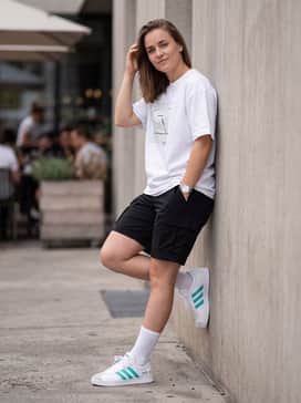 Mercedes  Amg Petronas Formula One Team Vl Court Shoes – Create a summer streetwear vibe with black cargo shorts, a white oversized graphic tee, and mid-calf white crew socks to frame the sneaker's profile.