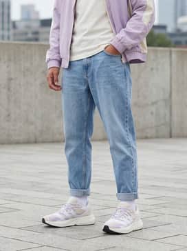 Mercedes  Amg Petronas Formula One Team Lightblaze Shoes – Relaxed-fit light-wash tapered jeans with a tucked-in white graphic tee featuring subtle purple accents and an off-white bomber jacket.