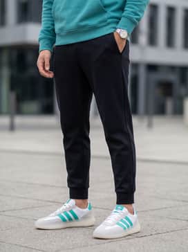 Mercedes  Amg Petronas Formula One Team Barreda Decode Shoes – Tapered black tech-fleece joggers combined with a teal graphic hoodie and a charcoal baseball cap for a cohesive, athletic-inspired streetwear ensemble.