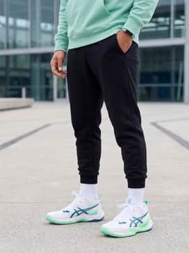 Metarise 2 – A modern athleisure ensemble consisting of tapered black tech-fleece joggers, a mint green oversized hoodie to echo the shoe's accents, and a sleek fitness tracker.