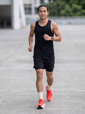 Race-day ready: A lightweight, moisture-wicking black running singlet paired with ultra-short split racing shorts and thin technical crew socks for maximum speed and breathability.