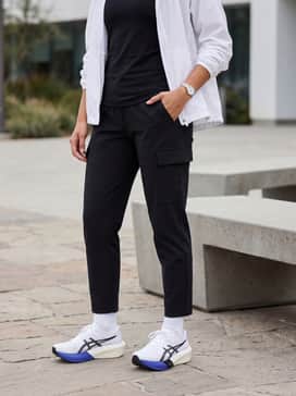 Tapered black technical cargo pants and an oversized white windbreaker to lean into a futuristic streetwear aesthetic.