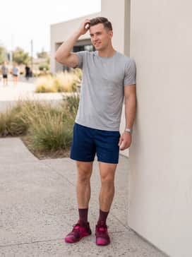 Summer workout ensemble: Style with navy blue mesh athletic shorts and a light gray technical t-shirt to let the vibrant maroon and pink hues stand out.