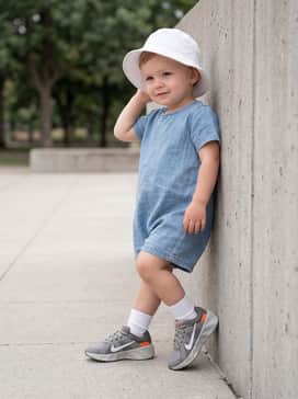 Match with a light denim romper and a white sun hat for a cute and functional outfit for outdoor family gatherings.