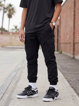 Midcity Low Shoes – Black tapered cargo pants and a white oversized t-shirt with a utility vest to lean into an urban techwear aesthetic.