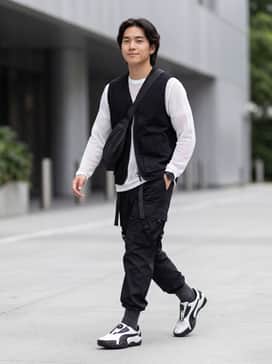 Pair with black technical cargo pants featuring multiple straps, a white mesh base layer under a black utility vest, and a sleek nylon crossbody bag for a full techwear look.