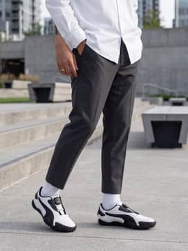 Combine with cropped, tapered charcoal trousers, a crisp white oversized button-down shirt, and a silver chain necklace for a sophisticated yet edgy minimalist ensemble.