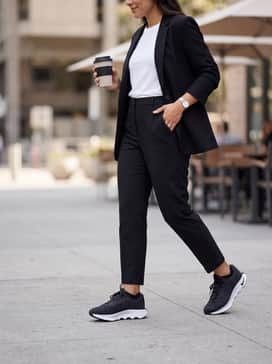 Classic weekend comfort with light-wash boyfriend jeans rolled at the cuff, a tucked-in white t-shirt, and a structured black blazer for an elevated casual aesthetic.