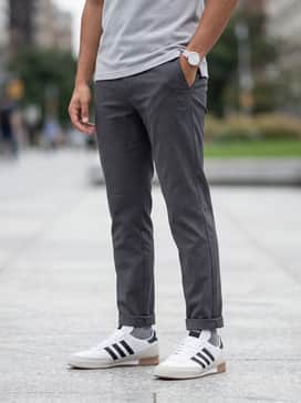 Mundial Goal Shoes – Navy blue tapered chinos worn with a classic pique polo in light grey and a minimalist silver watch for a smart-casual weekend vibe.