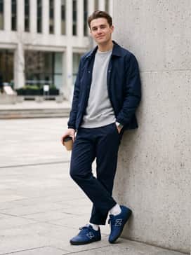 Tapered charcoal joggers with a matching oversized navy hoodie and white crew socks pulled slightly up for a clean, athletic vibe.