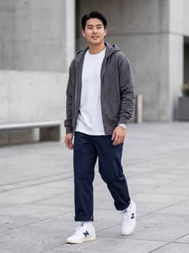 Nb Numeric Brandon Westgate 508 – A pair of relaxed-fit navy blue chinos rolled at the hem, paired with a heavyweight white cotton t-shirt and a dark grey zip-up hoodie for a classic skate look.