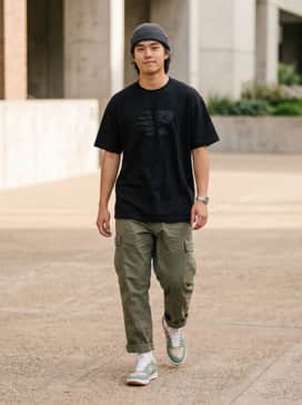 Pair with relaxed-fit olive cargo pants, a heavy-weight white graphic t-shirt, and a black fisherman beanie for an authentic skate-inspired look.
