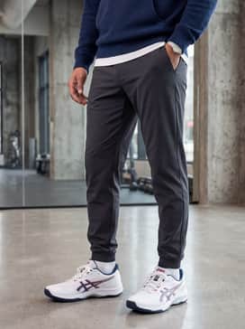 Relaxed weekend style: Slim-fit grey joggers, a navy blue zip-up hoodie, and a basic white cotton t-shirt for a cohesive, sporty aesthetic.