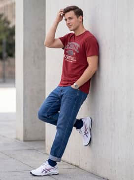 Off-duty casual: Tapered indigo denim jeans cuffed at the ankle to showcase the shoe's profile, paired with a red graphic tee that picks up the shoe's accent colors.
