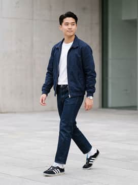 Newcastle Spzl Fc Shoes – Dark indigo slim-fit denim paired with a white premium cotton tee and a navy blue Harrington jacket for a timeless terrace look.