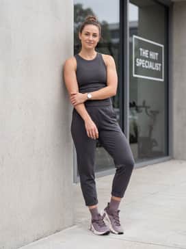 Nike Free Metcon 6 – Charcoal grey tapered joggers and a fitted rib-knit tank top for a comfortable yet put-together ensemble perfect for errands or travel.