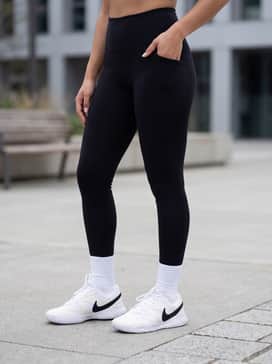 Nikecourt Lite 4 – High-waisted black leggings and a cropped grey hoodie, finished with white crew socks pulled up over the leggings.