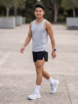 Novablast 5 Atc – A high-performance look featuring black 5-inch split running shorts, a neon-accented moisture-wicking singlet, and white performance socks to keep the focus on the sleek silver footwear.