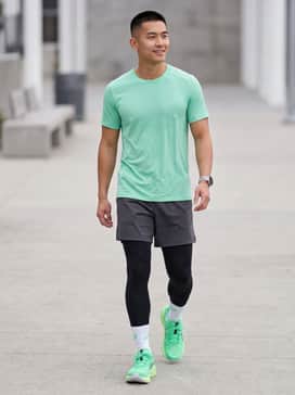 Novablast 5 Ekiden – A technical running kit featuring black compression leggings under charcoal grey 5-inch mesh shorts and a seamless mint green performance t-shirt.