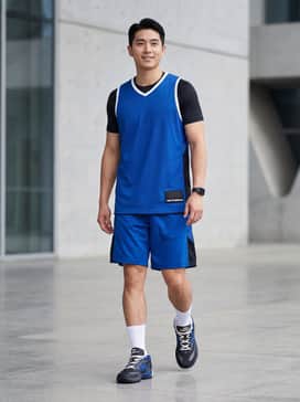 A royal blue mesh basketball jersey paired with matching performance shorts and white mid-calf athletic socks.