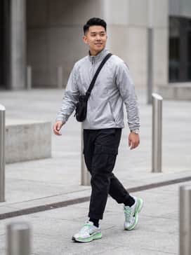 P6000 Se – A monochromatic grey techwear ensemble featuring utility cargo pants and a matching windbreaker to highlight the silver tones and pop of green.