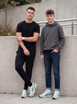 P6000 Se – Black tapered joggers with a crisp white performance tee and a neon green accessory like a beanie to mirror the shoe's vibrant accents.