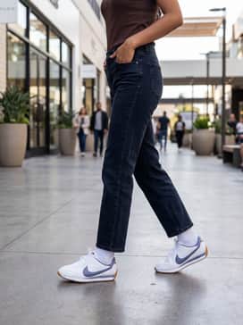Pacific Leather – Dark-wash straight-leg jeans paired with a cream-colored oversized cable-knit sweater for a sophisticated yet cozy autumnal aesthetic.