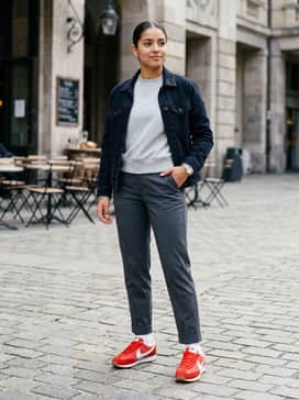 Relaxed boyfriend jeans in a light wash, a grey oversized hoodie, and a minimalist black leather backpack for an effortless street-ready look.