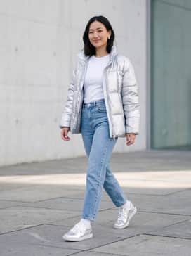 Palermo Chrome – High-waisted light wash straight-leg jeans paired with a tucked-in white baby tee and an oversized silver metallic puffer jacket for a cohesive, futuristic streetwear look.