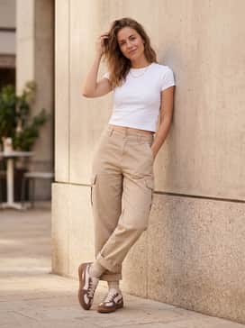 Palermo Wine Club Womens Sneakers – Relaxed-fit beige cargo trousers, a fitted white baby tee, and a collection of gold dainty jewelry for a utilitarian-chic vibe.