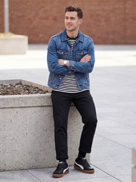 Straight-leg black chinos, a tucked-in striped long-sleeve tee, and a denim jacket for a clean, casual weekend outfit.