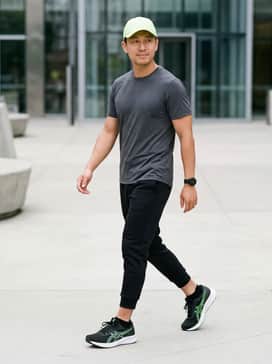 Patriot 14 – Black tech-fleece joggers paired with a moisture-wicking charcoal grey t-shirt and a matching neon green baseball cap for a cohesive workout look.