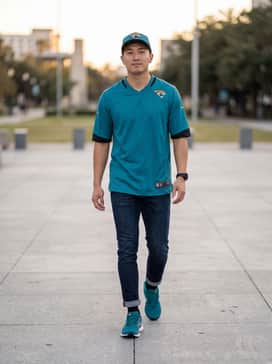 A Jacksonville Jaguars home jersey paired with dark-wash slim-fit jeans and a matching team cap for the ultimate stadium look.