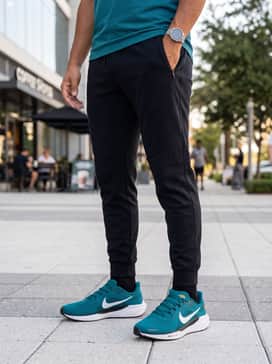 Pegasus 41 – Black tapered tech-fleece joggers combined with a fitted white moisture-wicking t-shirt and a lightweight black windbreaker for a sleek athletic vibe.
