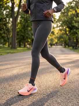 A professional athletic kit with a charcoal grey technical running jacket, high-waisted charcoal leggings, and these shoes to provide a pop of color to a neutral base.