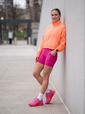 Pegasus Premium – Go for a coordinated athletic look with fuchsia biker shorts and a cropped neon orange windbreaker, creating a high-visibility monochromatic outfit perfect for early morning runs.