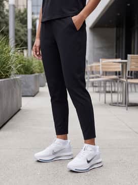 Pegasus Premium – Tapered black athletic joggers worn with a fitted white moisture-wicking long-sleeve top and thin white performance socks for a streamlined, functional training look.