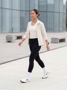 Performance Ready: Match with high-waisted black compression leggings, a moisture-wicking cream racerback tank, and thin white performance socks.