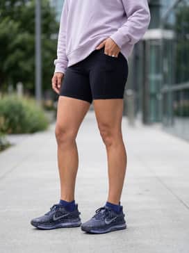 Pegasus Premium Se – Matte black biker shorts with a lilac oversized hoodie that picks up the subtle purple tones in the translucent Air Zoom sole.