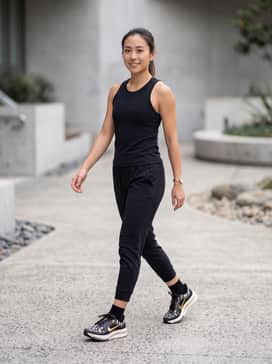 Pegasus Premium – High-waisted black compression leggings and a cropped performance tank in a matching noir shade to make the metallic gold swoosh the center of attention.