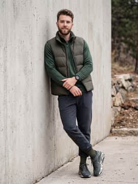 Pegasus Trail 5 Goretex – Dark grey tapered tech-fleece joggers paired with a forest green quarter-zip pullover and a down-insulated utility vest for a comfortable yet rugged outdoor ensemble on cooler days.
