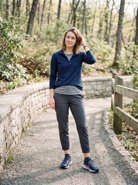 Pegasus Trail 5 – A clean athletic casual ensemble consisting of charcoal grey tapered joggers, a crisp white moisture-wicking t-shirt, and a navy quarter-zip pullover.