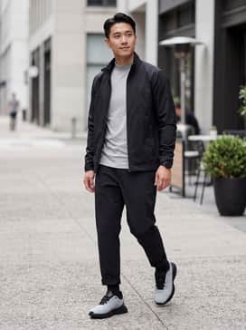Porsche Design 3d Matrix Iii 3d Mtrx Iii – Black tapered technical trousers, a light grey performance mock-neck, and a minimalist black shell jacket for a cohesive tech-wear aesthetic.