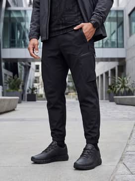 Porsche Xetic V Mens Sneakers – A futuristic techwear aesthetic combining black utility cargo joggers with a fitted graphic tee and a matte technical windbreaker.